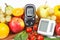 Glucometer, blood pressure monitor and fruits with vegetables, healthy lifestyle