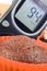 Glucometer for checking sugar level and fresh chocolate muffins. Diabetes and delicious dessert for diabetics