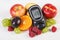 Glucometer and fresh fruits, diabetes and healthy nutrition