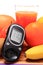 Glucometer, fresh natural fruits and glass of juice