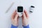 Glucometer in the hands of caucasian woman. Measuring blood sugar. White background