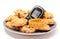 Glucometer, oatmeal cookies and tape measure on colorful plate