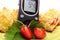 Glucometer and pieces of yeast cake with strawberries