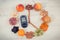 Glucometer with result sugar level and clock made of fruits, time for resolutions of healthy nutrition concept