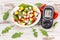 Glucometer with result of sugar level and fresh salad with eggs and vegetables, diabetes and healthy nutrition concept
