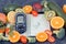 Glucometer with result of sugar level, fruits with vegetables and notepad with word diet. Healthy food for diabetic concept