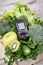 Glucometer with result sugar level and green natural fruits with vegetables. Body detox and healthy nutrition during diabetes