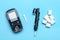 glucometer, sugar cubes on blue background High blood sugar and diabetes concept Top view Flat lay 14 November - World Diabetes