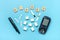 glucometer, sugar cubes on blue background High blood sugar and diabetes concept Top view Flat lay 14 November - World Diabetes