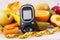 Glucometer, tape measure and fresh natural fruits containing vitamins for healthy lifestyles of diabetics