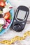 Glucometer, tape measure and greek salad with feta cheese and vegetables. Best food for diabetics, dieting and slimming