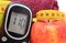 Glucose meter, fresh apple and tape measure