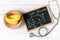 Glucose molecule on blackboard with banana and stethoscope