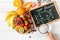 Glucose molecule on blackboard with mixed fresh fruits salad