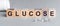 Glucose is a word written in black letters on wooden cubes