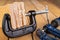 Glued pieces of wood and carpentry clamp on a wooden table. Carpentry accessories in a wood workshop