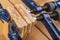 Glued pieces of wood and carpentry clamp on a wooden table. Carpentry accessories in a wood workshop