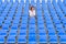 Glum woman sitting in spectator seating