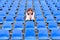 Glum woman sitting in spectator seating