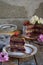 Gluten-free and dairy-free cake decorated with white roses and coconut: chocolate-nut biscuit, berry mousse, custard on almond mil