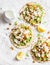 Gluten free flatbread with roasted chickpeas, cauliflower and avocado dip on a light background, top view. Healthy vegetarian food