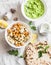 Gluten free flatbread, roasted chickpeas, cauliflower and avocado dip on a light background, top view. Healthy vegetarian food con