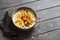 Gluten free pumpkin and apple porridge. Nut milk oatmeal with pumpkin, apples and honey on wooden brown background.