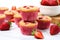 gluten-free strawberry muffins with fresh strawberries scattered around