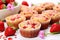 gluten-free strawberry muffins with fresh strawberries scattered around