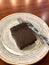 Gluten Free and Sugar Free Chocolate Flourless Cake Cooked with Almond Flour served at Cafe Shop in Plate Fork and Knife