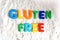 Gluten free text spelled out with colored letters in white flour