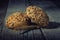 Gluten free whole grain buns on wooden table on dark background