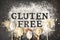 Gluten free written in flour on vintage baking sheet and spoons of various gluten free flour almond flour, buckwheat