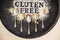 Gluten free written in flour on vintage baking sheet and spoons of various gluten free flour almond flour, buckwheat