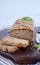 Glutenfree buckwheat bread with a golden brown crust, sprinkled with sunflower seeds, lies on a wooden table. Healthy homemade