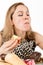 Glutton woman eating cupcakes with frenzy after long diet