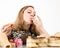 Glutton woman eating cupcakes with frenzy after long diet