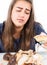 Glutton woman eating cupcakes with frenzy after long diet