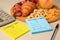 Glycemic index. Notes with information, measuring tape, calculator, pen and products on beige background, closeup