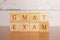 GMAT. Graduate Management Admission Test or exam in wooden block letters