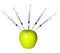 GMO food concept. Genetically modified green apple and syringes isolated. Genetic injections