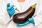GMO scientist injecting liquid from syringe into eggplant