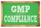 GMP COMPLIANCE words on green wooden frame school blackboard