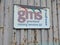 GMS sign advertising Greenland Mining Services on side of rusting metal container