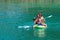GMUNDEN, AUSTRIA, - AUGUST 08, 2018: Family with dog on Paddle Board at the lake. SUP.