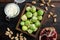 Gnarly garlic brussels ingredients, on old wooden table, top view