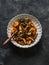Gnocchetti pasta with bolognese sauce and spinach on a dark background, top view. Delicious comfort food