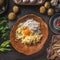 Gnocchi dough ingredients. Potatoes with egg and flour in wooden bowl on dark kitchen table with organic ingredients for tasty