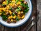 Gnocchi with fried white mushrooms, green peas, parmesan and parsley on wooden table, top view