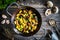 Gnocchi with fried white mushrooms on wooden table